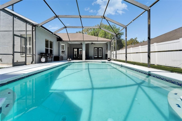 view of swimming pool with a fenced in pool, french doors, a ceiling fan, and fence