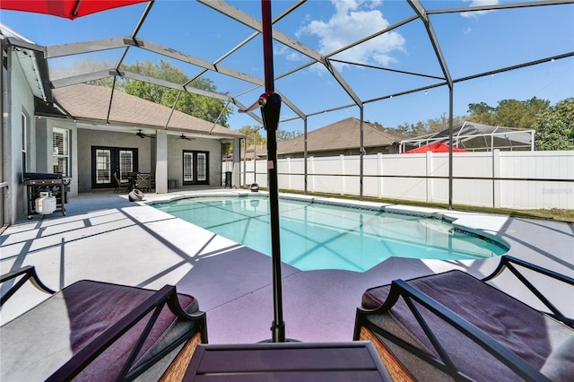 view of swimming pool featuring a patio, a ceiling fan, a fenced in pool, fence, and french doors