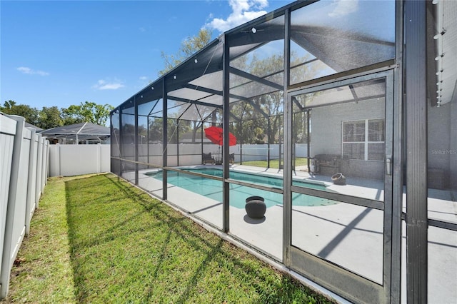 view of swimming pool with a lawn, a fenced backyard, a fenced in pool, a lanai, and a patio area