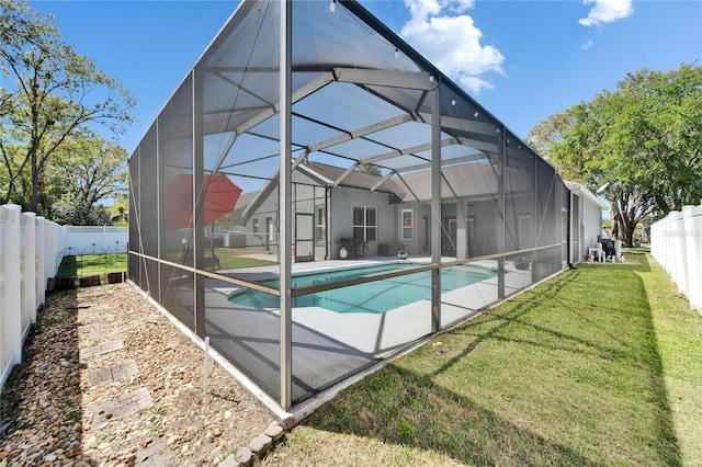 view of pool featuring a yard, a fenced in pool, a fenced backyard, and glass enclosure