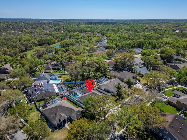 birds eye view of property with a residential view and a view of trees