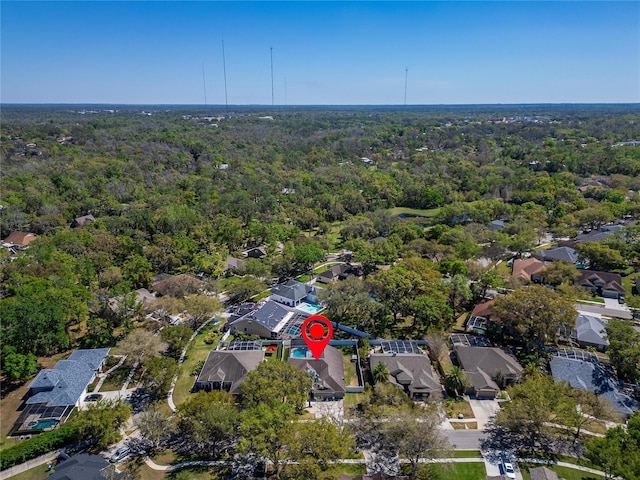 aerial view featuring a view of trees and a residential view