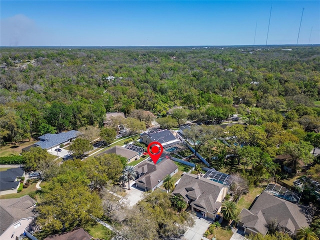 drone / aerial view with a residential view and a wooded view