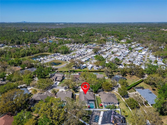 bird's eye view with a water view, a forest view, and a residential view