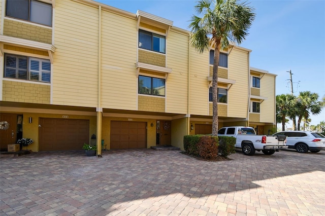 view of property with driveway and an attached garage