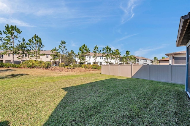 view of yard with a residential view and fence