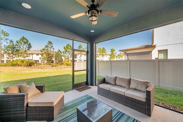 sunroom / solarium featuring ceiling fan