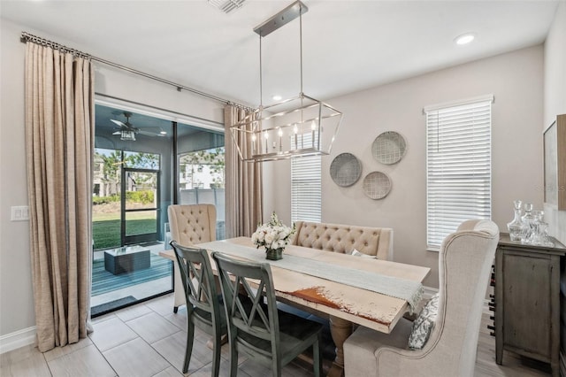 dining space with recessed lighting, ceiling fan with notable chandelier, and baseboards