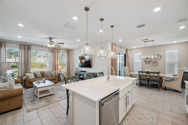 kitchen with open floor plan, a sink, visible vents, and stainless steel dishwasher