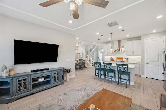 interior space featuring wood finish floors, visible vents, recessed lighting, and stairs