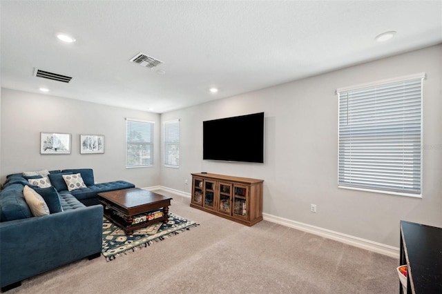 living room featuring recessed lighting, baseboards, visible vents, and carpet floors