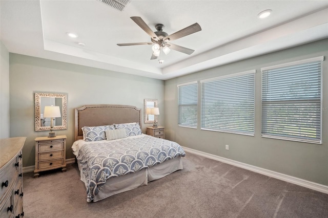 bedroom with visible vents, carpet floors, a raised ceiling, and baseboards