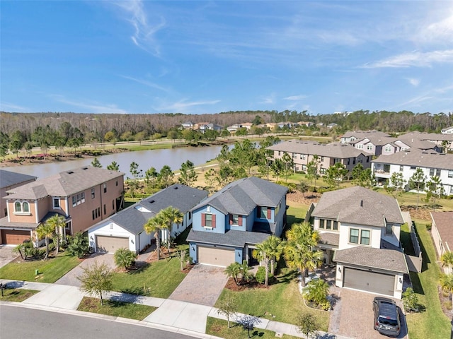 drone / aerial view featuring a residential view and a water view