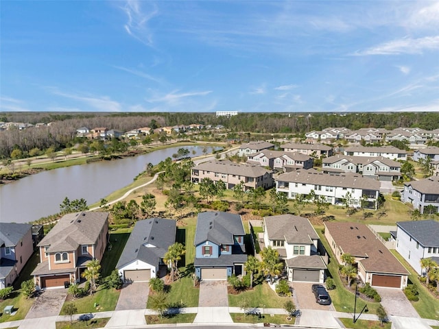 drone / aerial view featuring a residential view and a water view