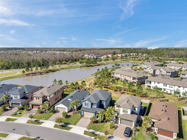 drone / aerial view featuring a residential view and a water view