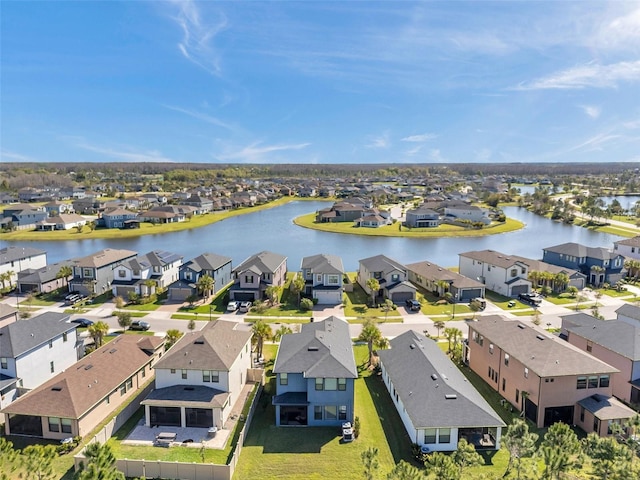 birds eye view of property featuring a residential view and a water view