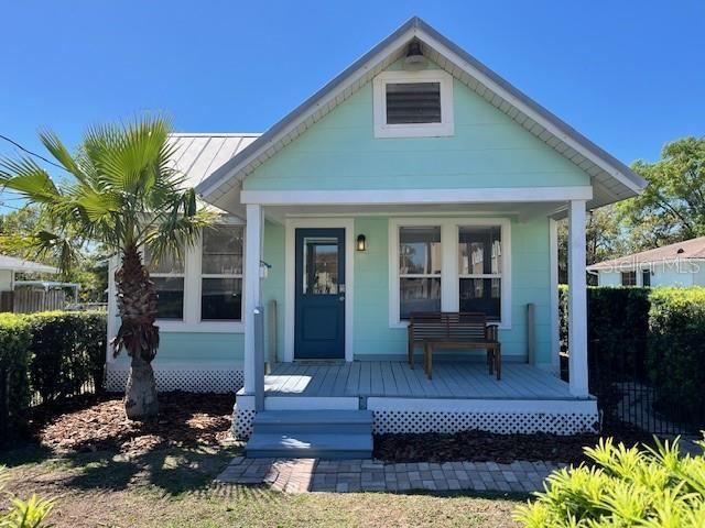 view of front of property with metal roof, covered porch, and a standing seam roof