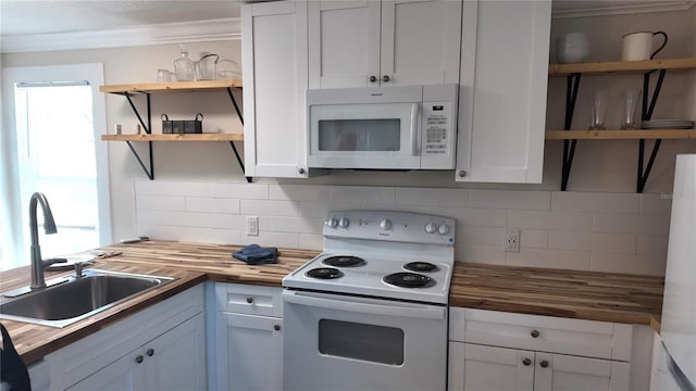 kitchen with a wealth of natural light, open shelves, a sink, white appliances, and wooden counters