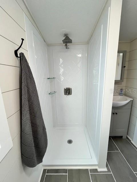 bathroom featuring a stall shower and vanity