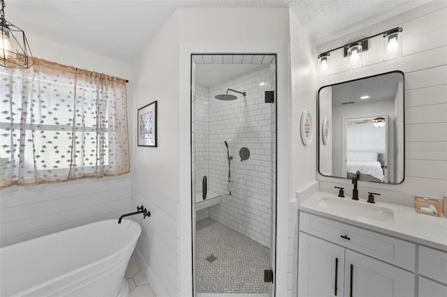 bathroom with vanity, ensuite bath, a freestanding tub, and a shower stall