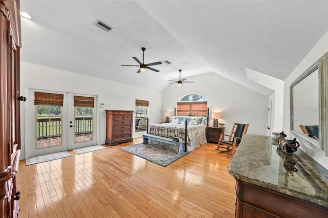 bedroom featuring visible vents, lofted ceiling, access to exterior, french doors, and light wood-type flooring