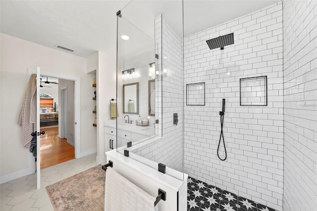 bathroom featuring visible vents, a walk in shower, vanity, tile patterned floors, and ensuite bath