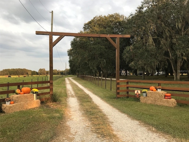 view of property's community with a rural view and driveway