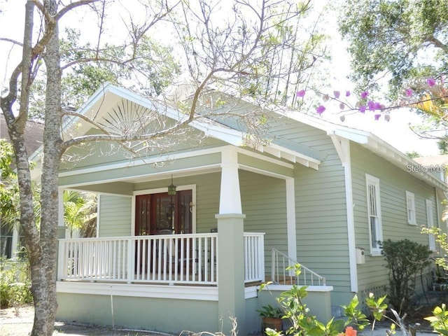 view of property exterior with covered porch