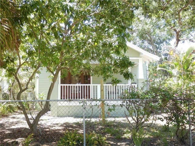 exterior space featuring a fenced front yard and covered porch