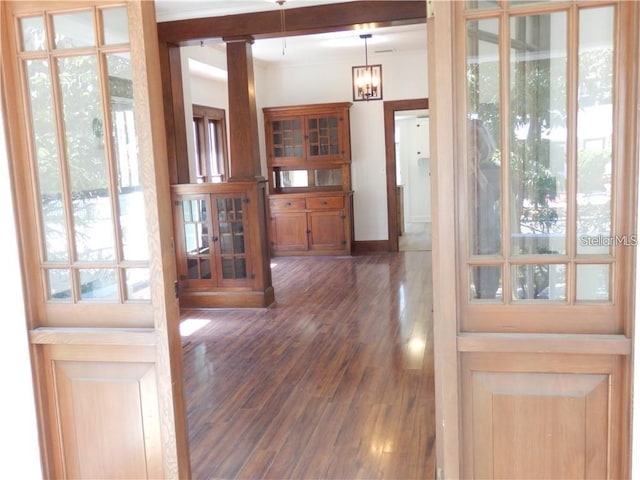 entrance foyer featuring baseboards, dark wood finished floors, and ornamental molding