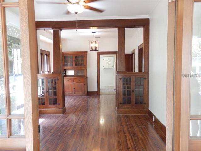 interior space with plenty of natural light, baseboards, dark wood-style flooring, and ceiling fan