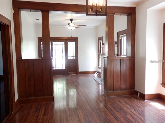 entrance foyer with dark wood-style floors, ceiling fan, baseboards, and decorative columns