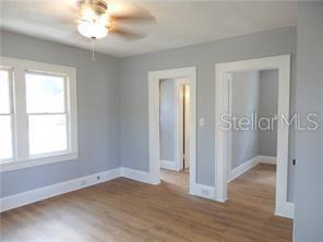 unfurnished bedroom with wood finished floors and baseboards