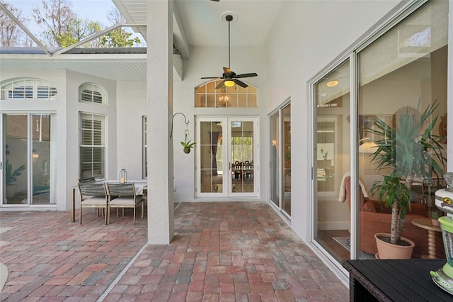 sunroom featuring french doors and a ceiling fan