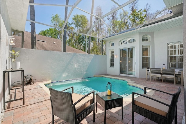 view of pool featuring a patio, a fenced in pool, fence, and a lanai