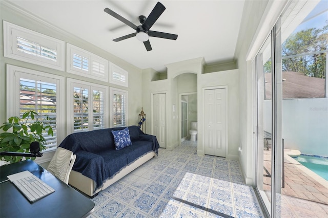 sunroom / solarium featuring ceiling fan