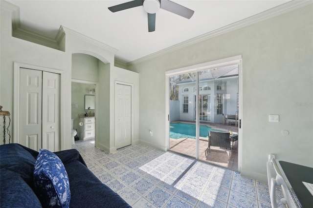 bedroom with access to exterior, two closets, crown molding, ceiling fan, and baseboards