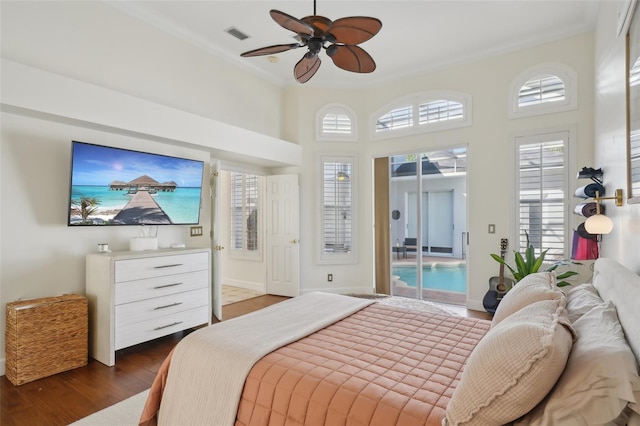 bedroom with visible vents, dark wood-type flooring, a ceiling fan, baseboards, and access to exterior