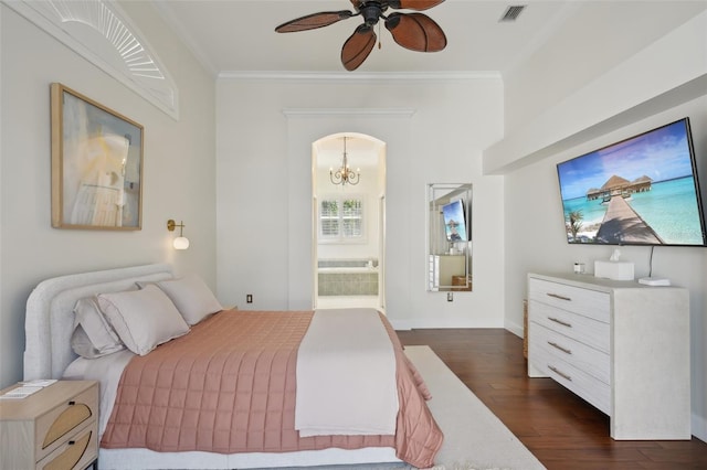 bedroom with visible vents, dark wood-type flooring, crown molding, ceiling fan with notable chandelier, and connected bathroom