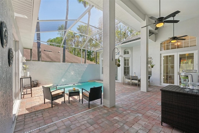 view of patio featuring a lanai, an outdoor pool, and ceiling fan