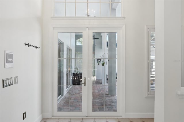 doorway featuring french doors and baseboards