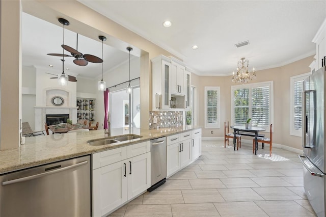 kitchen featuring a high end fireplace, crown molding, visible vents, and appliances with stainless steel finishes