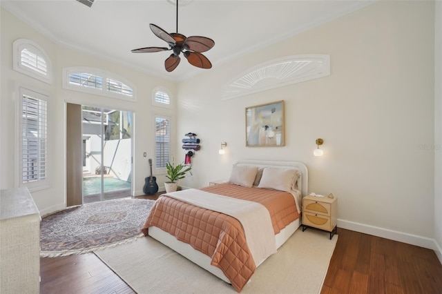 bedroom with wood finished floors, a ceiling fan, baseboards, and access to outside