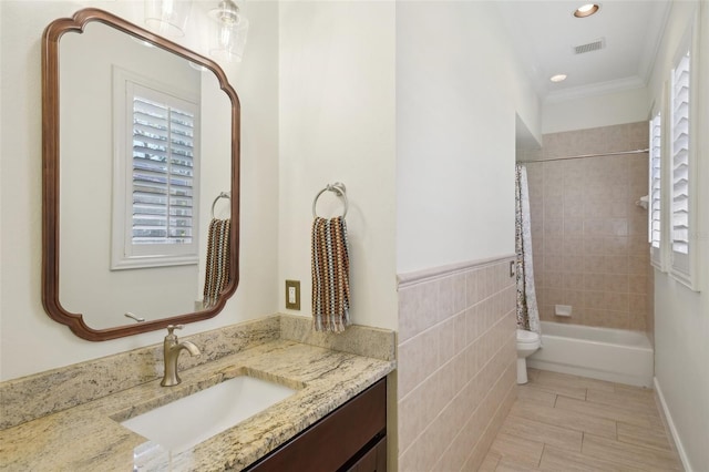 full bath featuring visible vents, tile walls, shower / bath combo with shower curtain, toilet, and vanity