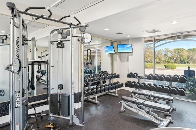 gym with recessed lighting, visible vents, and expansive windows