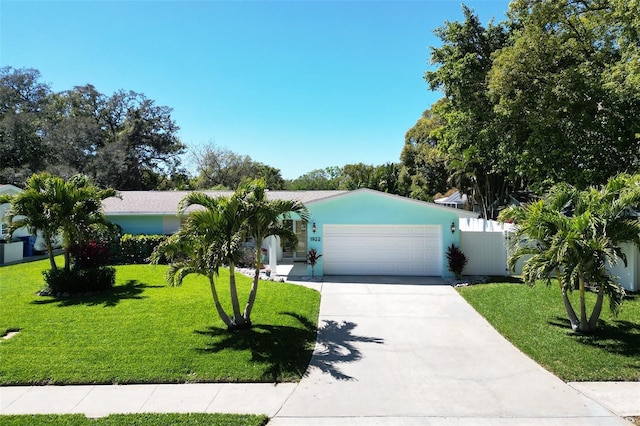 view of front of home with a front yard, an attached garage, and driveway