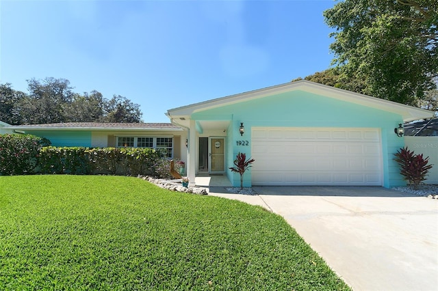 ranch-style house with driveway, a front lawn, and a garage