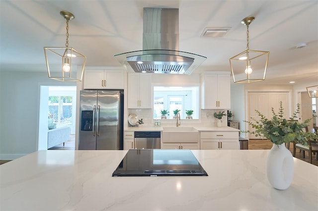 kitchen featuring a sink, stainless steel appliances, white cabinets, tasteful backsplash, and island range hood