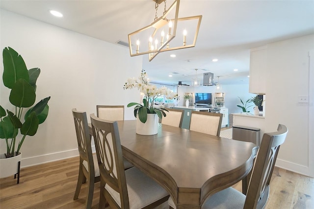 dining area featuring recessed lighting, baseboards, and light wood finished floors