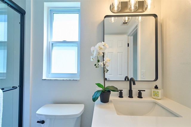 bathroom featuring toilet and vanity